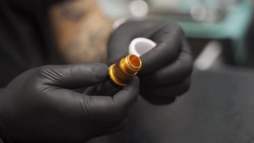 Close up of Tattoo Artist Preparing Cartridge Needle