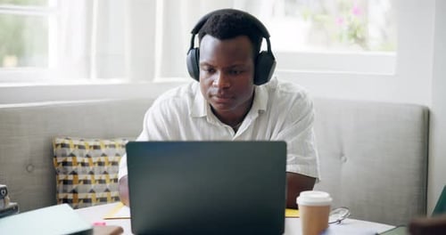 University, cafe and black man with headphones on laptop for online learning