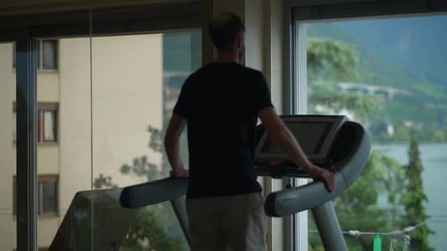A Man Exercises on a Treadmill in a Gym Highlighting an Active Lifestyle and Fitness