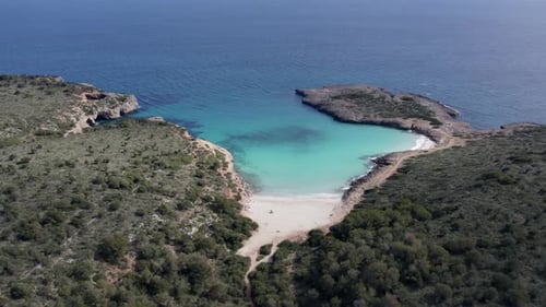 Aerial view of secluded beach and turquoise sea, Spain.