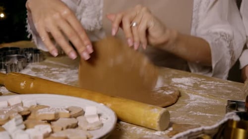 Hands Rolling Holiday Cookie Dough on Table