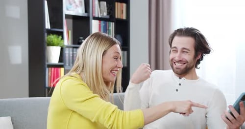 Happy Couple Celebrate Together on Smartphone