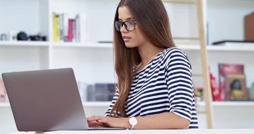 Woman Works at Laptop in Bright Home Office