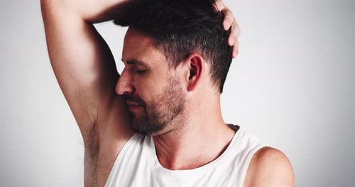 Man Smiles at Camera in Tank Top