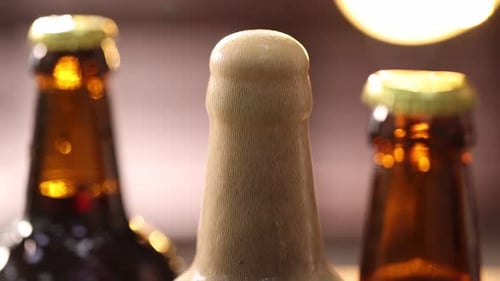 Foam Overflowing from Brown Bottle of Beer