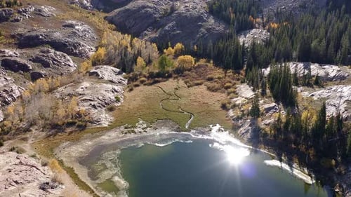 Aerial drone shot of Lake Blanche in Utah’s Big Cottonwood Canyon. Rotating bird's eye view of golde