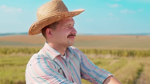 Portrait of a Smiling Adult Farmer in a Hat in Field of Cereals In the Sun Light Man Posing After a