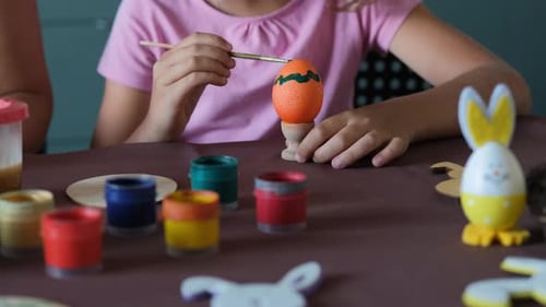 Closeup of Little Girl Painting Eggs for Easter