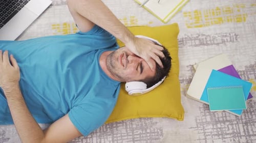 Depressed man listening to music and feeling sad.