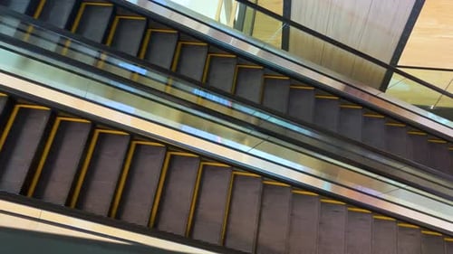 Close up two ways of activating escalators in a mall without people—side view from above of the esca