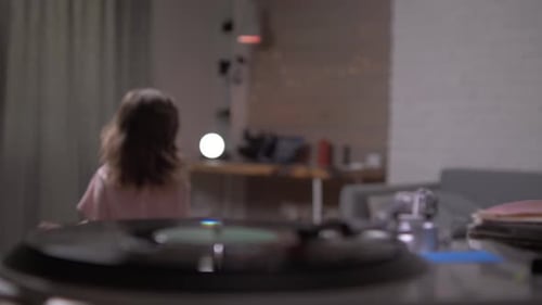 Girl Dancing to Music in Living Room at Home