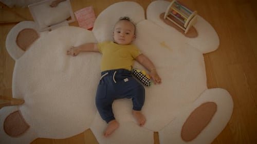 Playful Infant Baby Child Playing Inside at Home