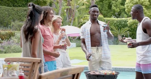 Friends Gather for a Backyard Cookout by Pool