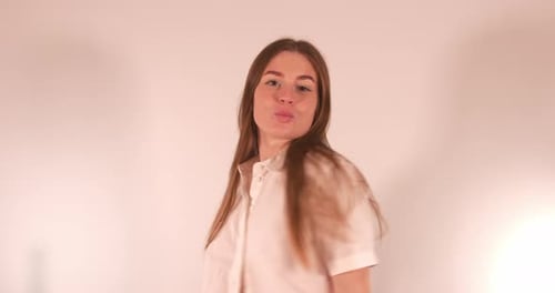 Sexy beautiful Girl dancing ina seducting way while grooming herself and smilling to the camera. Med