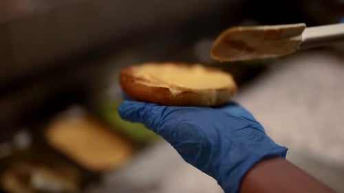 Closeup View of Cooking Hamburger Process in Kitchens of Fast Food Restaurant