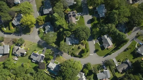 Top down drone shot rising above neighborhood homes, summer day in New York