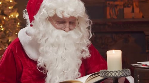 Santa Claus's Workshop Santa is Busy Wrapping a Gift at the Table with a Fireplace and Christmas