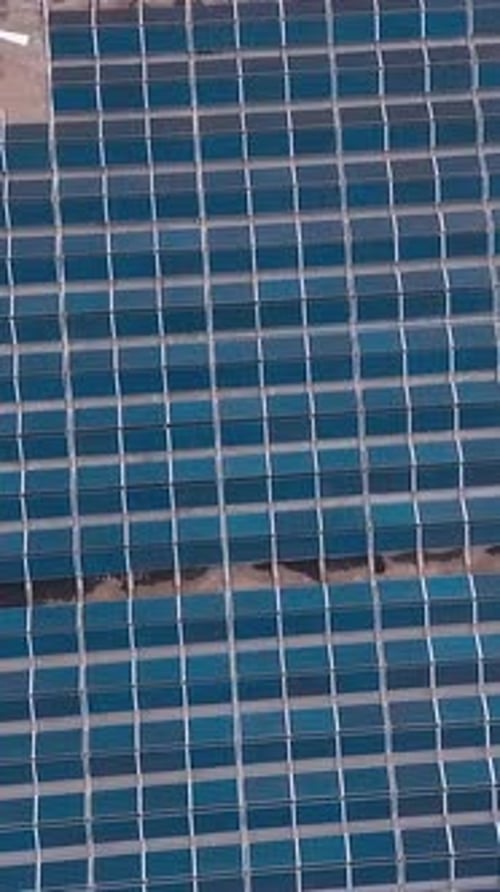 Solar Panels Installed On Roof. Top down view of large area solar photovoltaic panels on rooftop