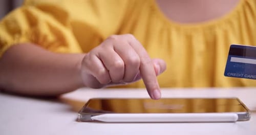 Encodage des informations de carte de crédit lors d'une transaction en ligne, à l'aide d'une tablette électronique.