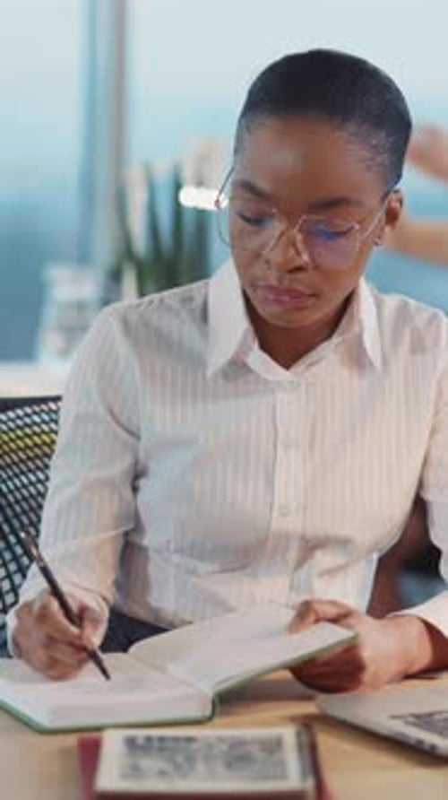 Attractive African American Office Executive Woman Using Laptop Computer Making Digital Presentation