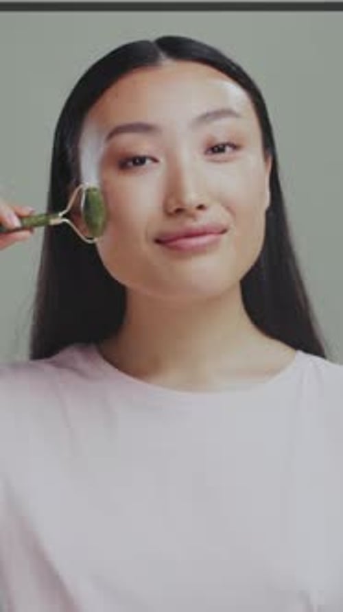 Graceful Jade Tool Relaxation Peaceful Ritual Involving Jade Roller to Soothe and Decongest Facial