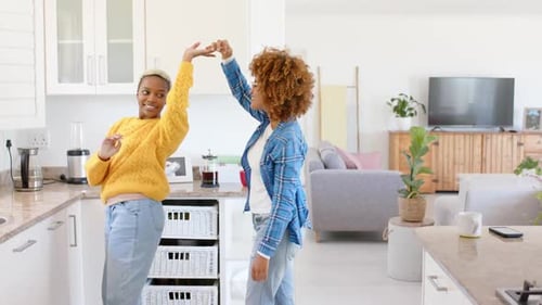 Women Dancing Together in a Bright Modern Home