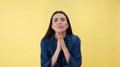 Caucasian Lady Keeping Hands in Prayer While Desperately Begging in Studio
