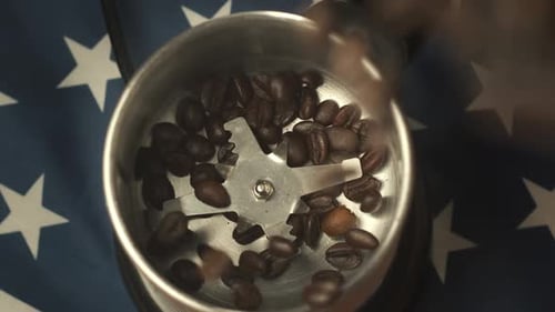 Closeup Shot of Roasting Coffee Beans Flying Into a Coffee Grinder Shot Against the Background of