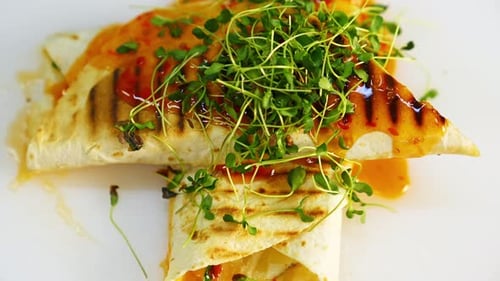 Delicious dish in the restaurant. Yummy pita poured with sauce on table.Tasty meal decorated