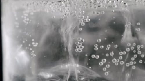 Sparkling Water Bubbles with Ice Cubes Close Up