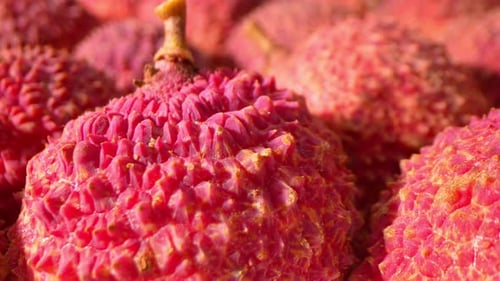 A vibrant close-up showcases lychee fruits.