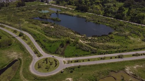 Aerial view of roundabout near small lake in countryside, Buenos Aires province. Argentine