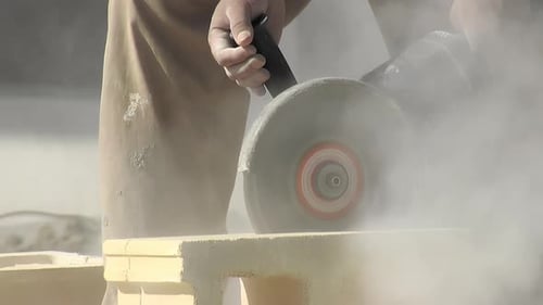 Worker Cuts Brick With Electric Power Saw