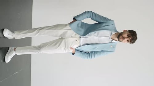 Man Poses Wearing a Stylish Jacket in Studio