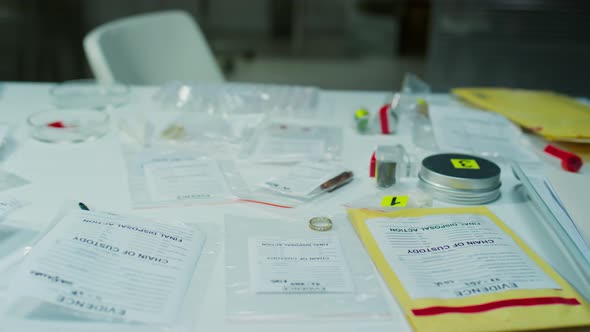 Evidence Bags, Containers and Test Tubes on Table of Forensic Scientist ...