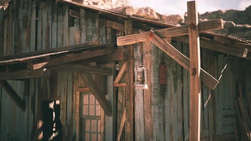 Rustic Wooden Cabin with Lantern in Desert Landscape During Golden Hour