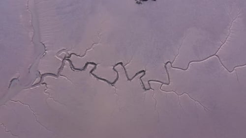 Maldon saltmarsh fractured estuary tidal mud flats at low tide on Essex marshland shoreline