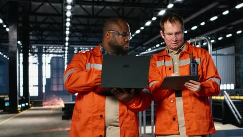 Diverse Workers Using Devices to Manage Steel Production Tasks