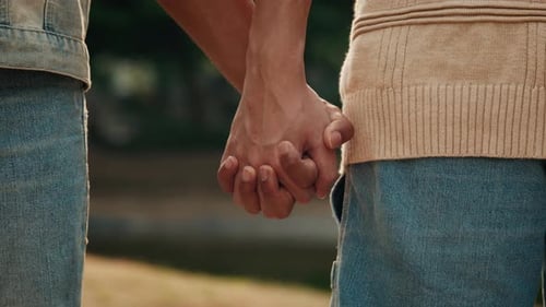 Young Man Takes Boyfriend Hand Walking Together in City