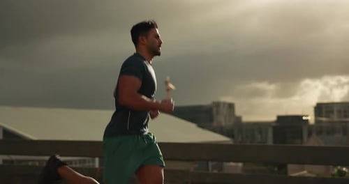 Running, fitness and man in city for exercise, marathon training and cardio workout in morning