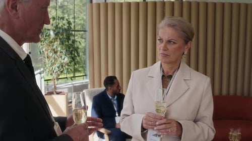 Business People Talking and Holding Champagne Flutes