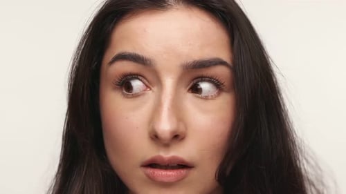 Scared Person Looking to the Side on Neutral Background
