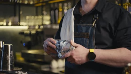 Closeup of a Bartender Rubbing a Beer Glass