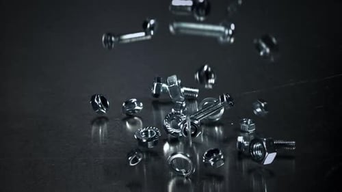 Falling Nuts Bolts and Washers on a Metal Table Filmed on a Highspeed Camera at 1000 Fps