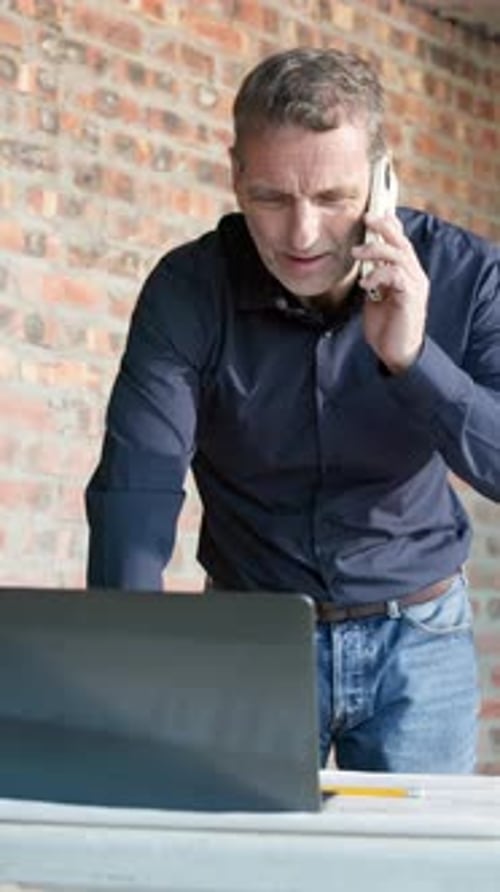 Laptop, architecture and mature man with phone call, conversation and update for building project