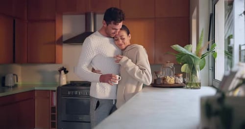 Couple Embracing in Kitchen Together