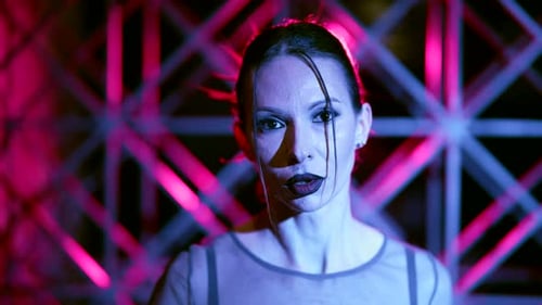 Woman with Brown Hair Posing in Front of Pattern