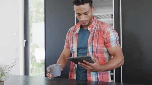 Man Using Tablet in Modern Home Kitchen