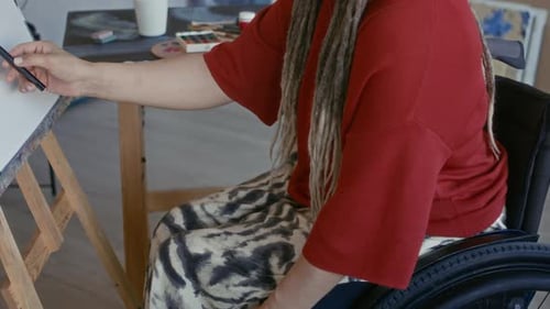 Young Adult in Wheelchair Drawing in Studio