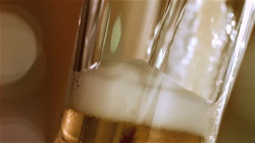 Beer Pouring into Glass with Foam